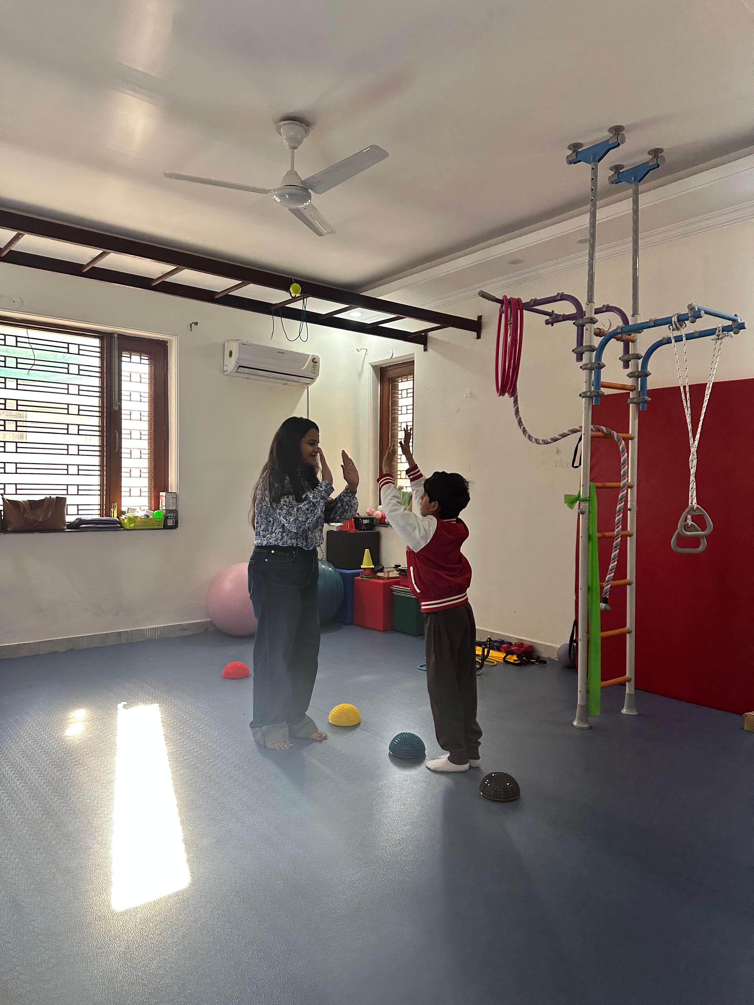 Therapist working with a child in sports therapy room